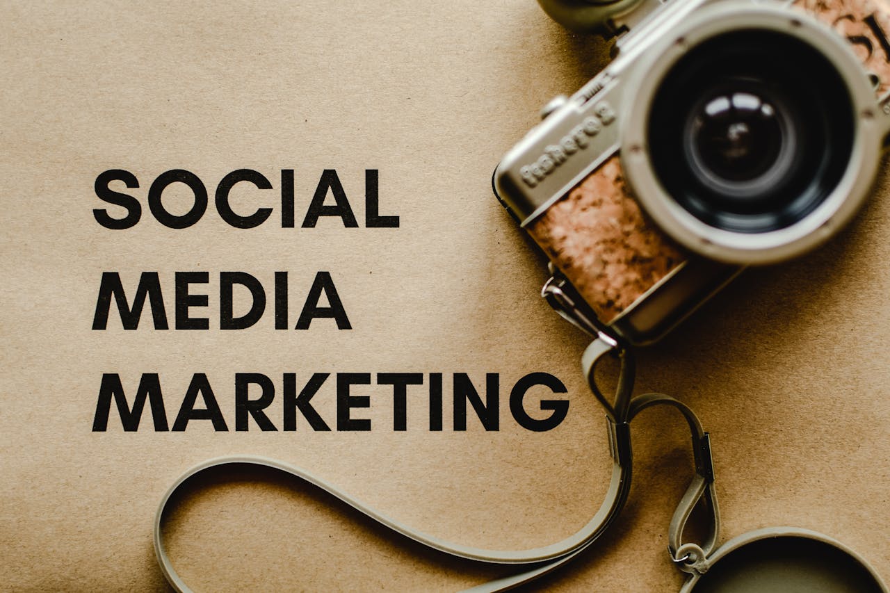 hero-img-02 A vintage camera on brown paper with 'SOCIAL MEDIA MARKETING' text, perfect for marketing visuals.